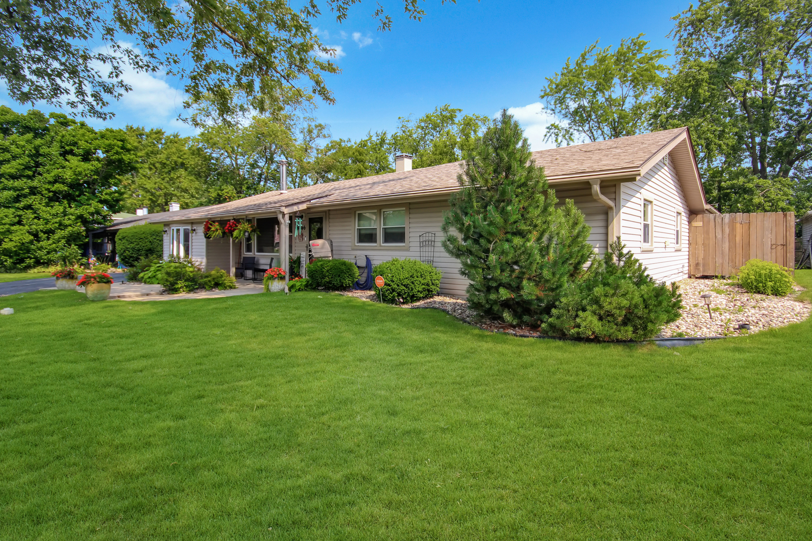 a front view of house with yard and green space