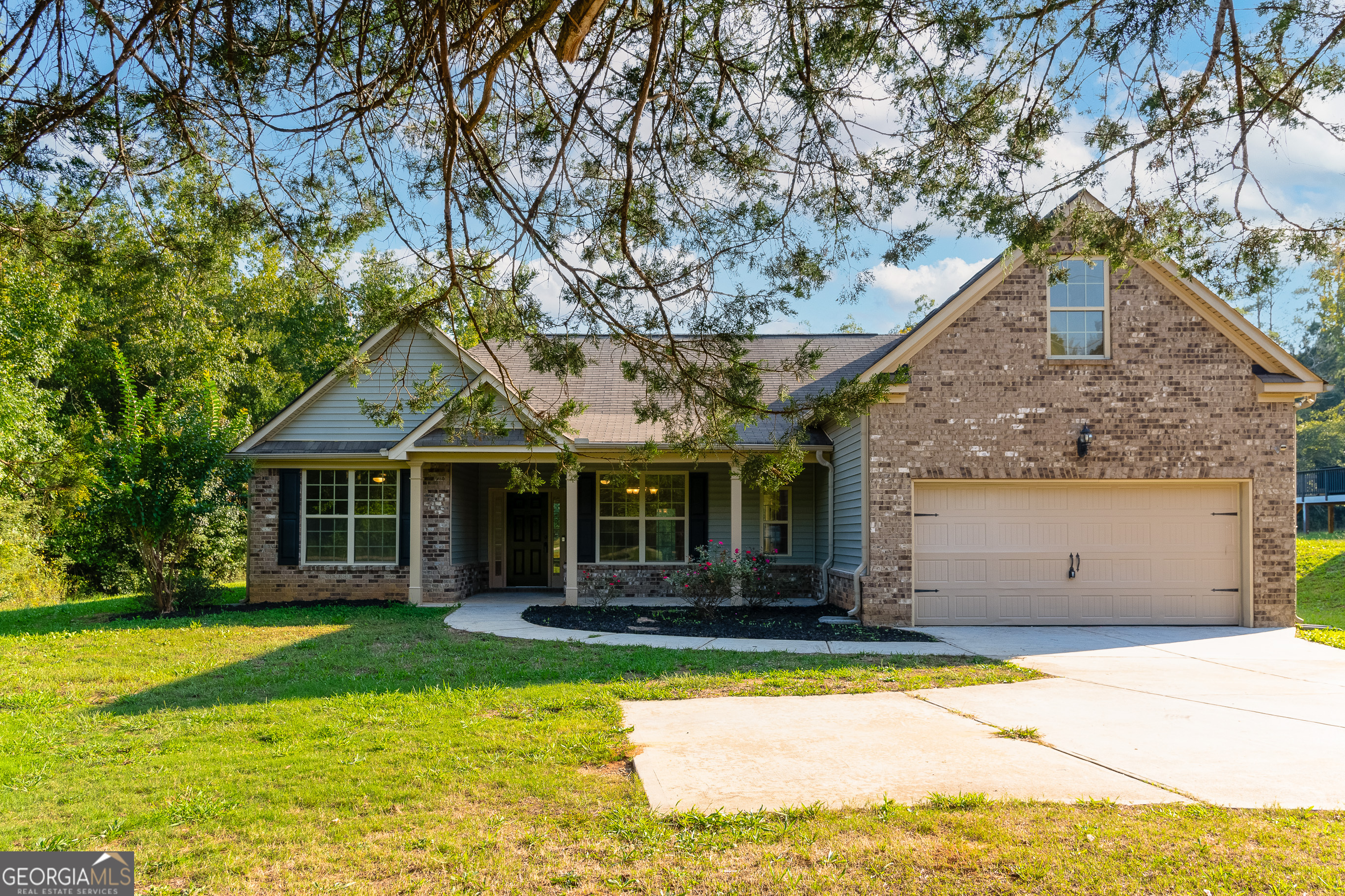 a front view of house with yard and green space