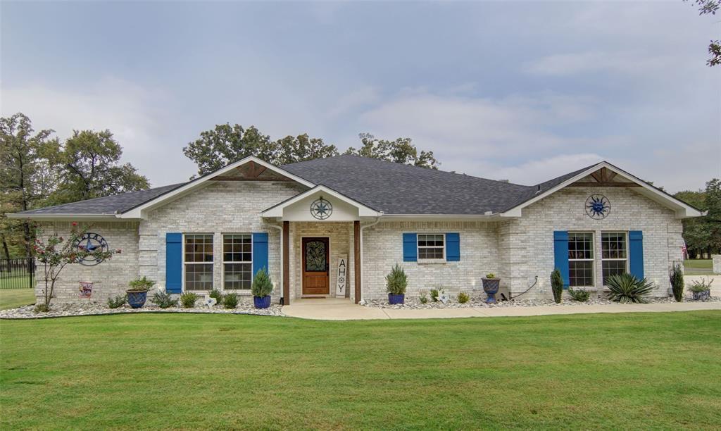 a front view of house with yard and green space