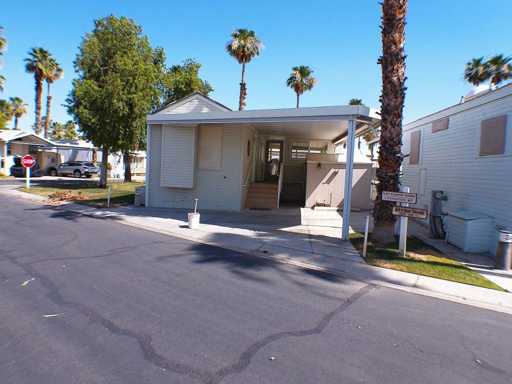 a view of a house with a patio and a yard