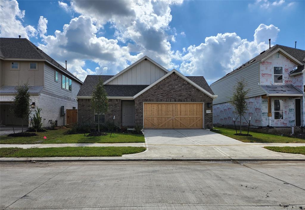 a front view of a house with a yard and a garage