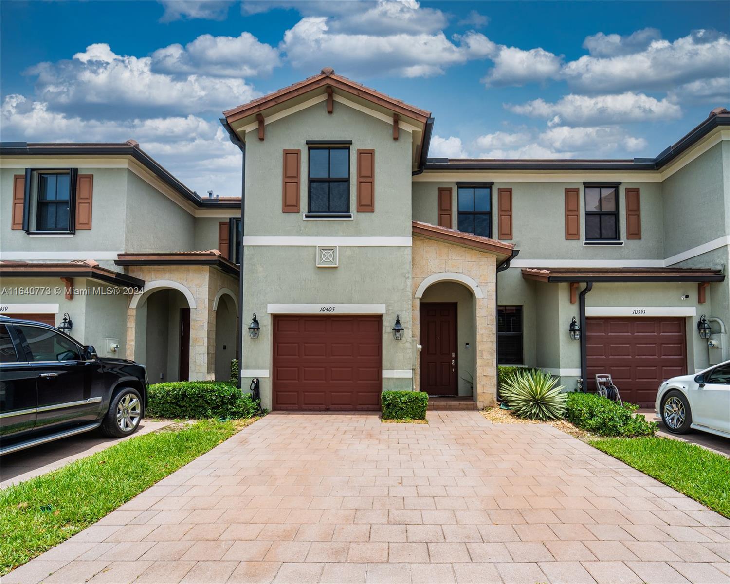 a front view of a house with a yard and garage