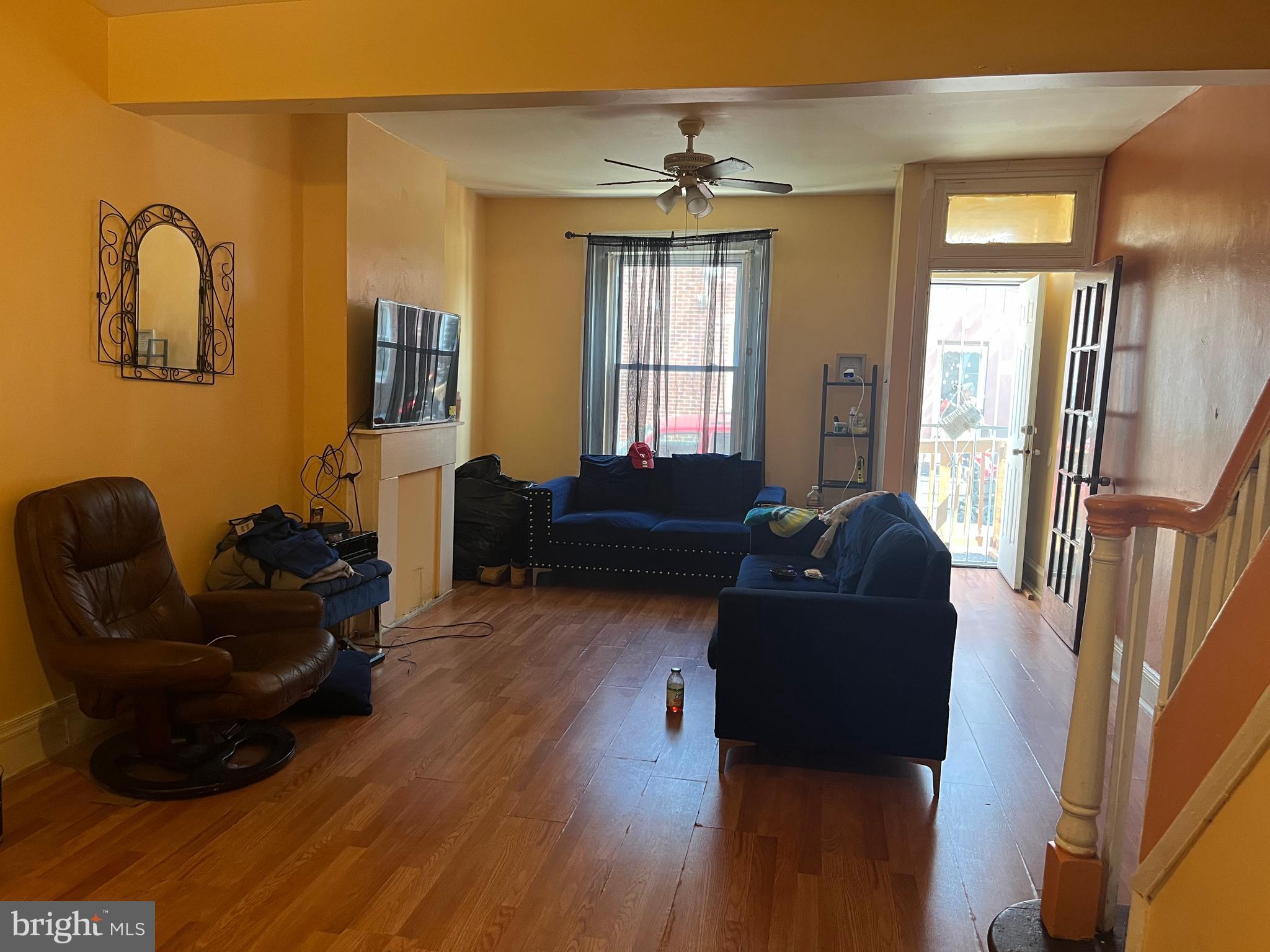 a living room with furniture and wooden floor