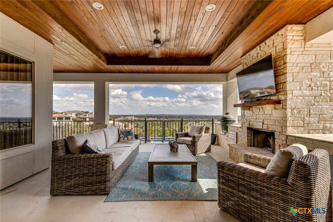 a living room with furniture fireplace and large windows