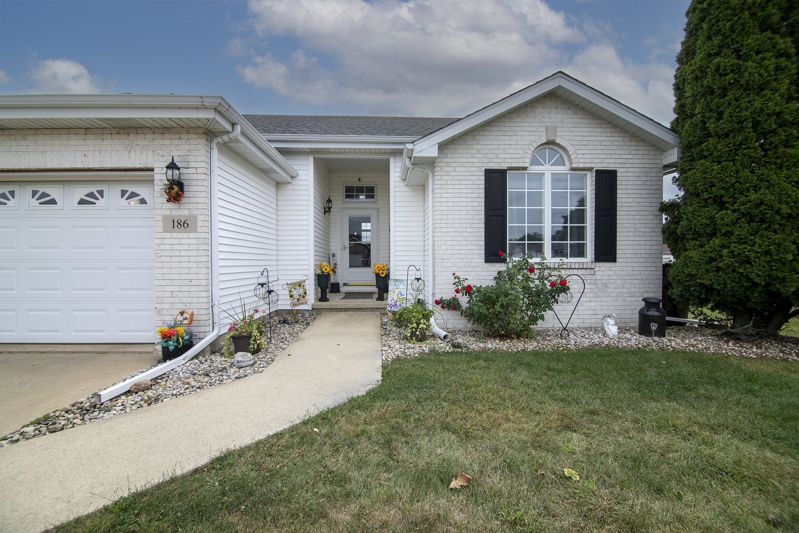 a front view of a house with a yard