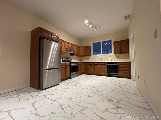 a kitchen with stainless steel appliances granite countertop a refrigerator sink and cabinets