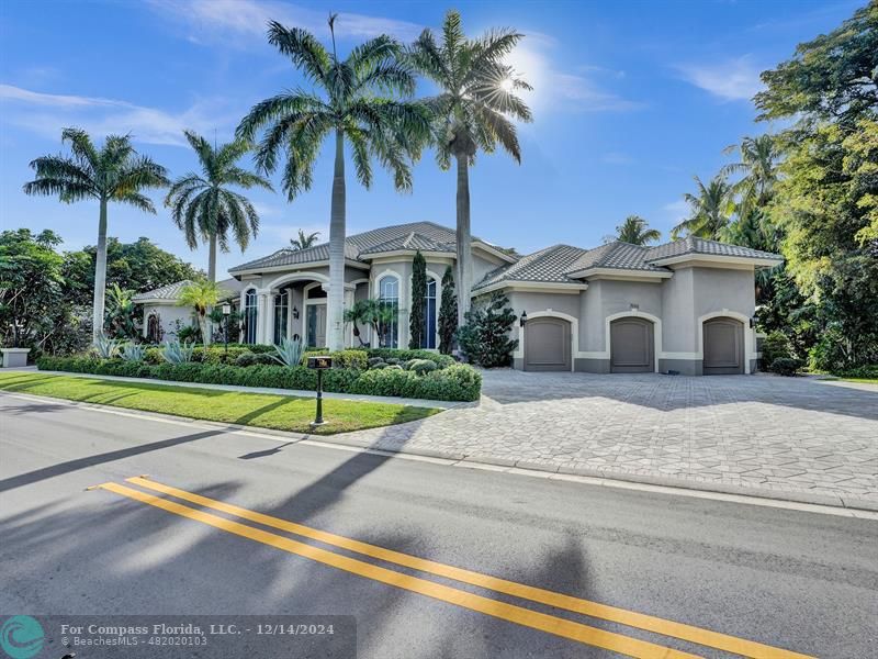 a view of multiple houses with palm trees