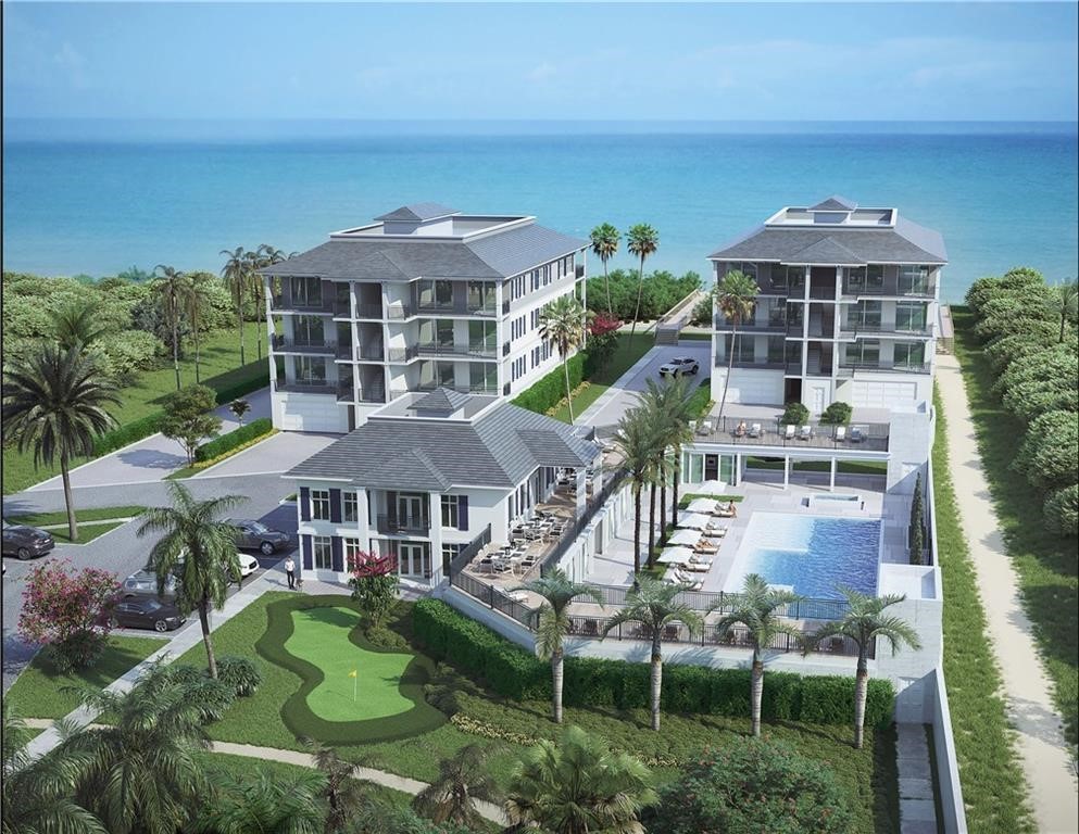 an aerial view of multiple houses with a yard