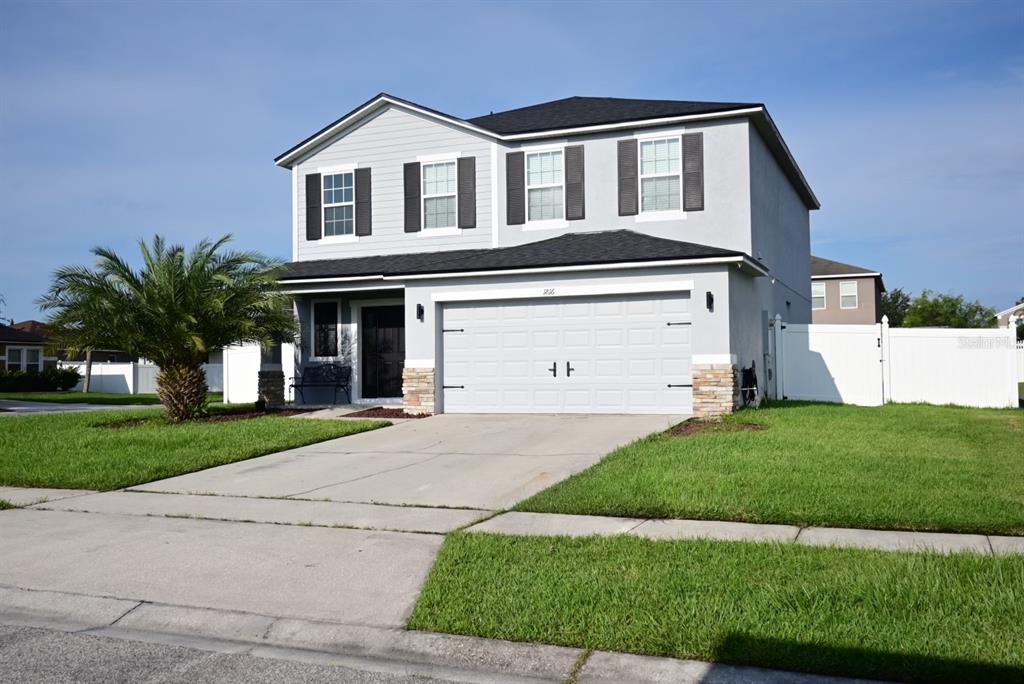 a front view of a house with a yard and garage