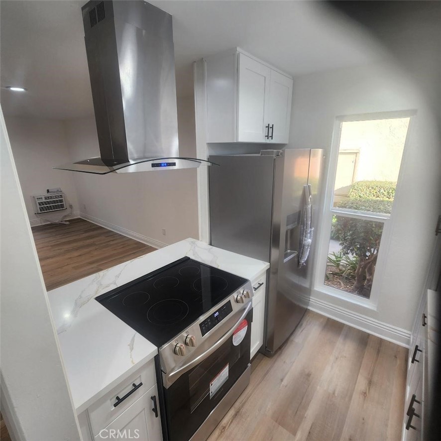 a kitchen with granite countertop a stove and a refrigerator