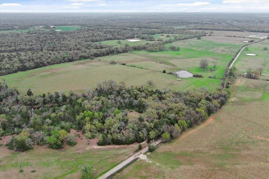 an aerial view of a houses with a yard