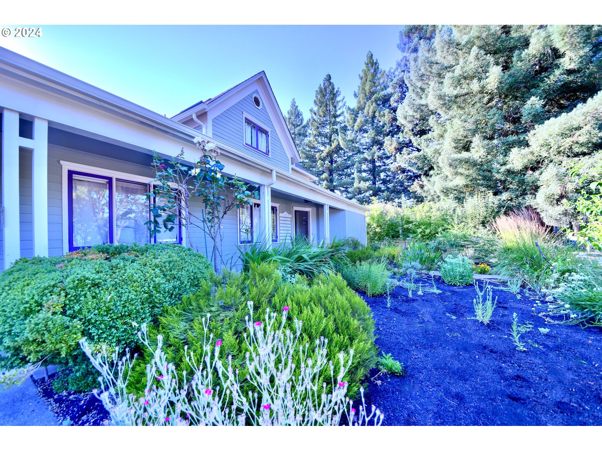 a view of a house with a flower garden