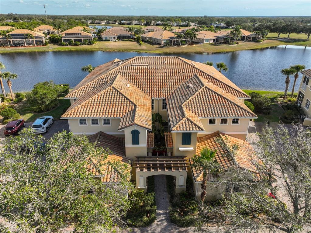 an aerial view of a house with a lake view