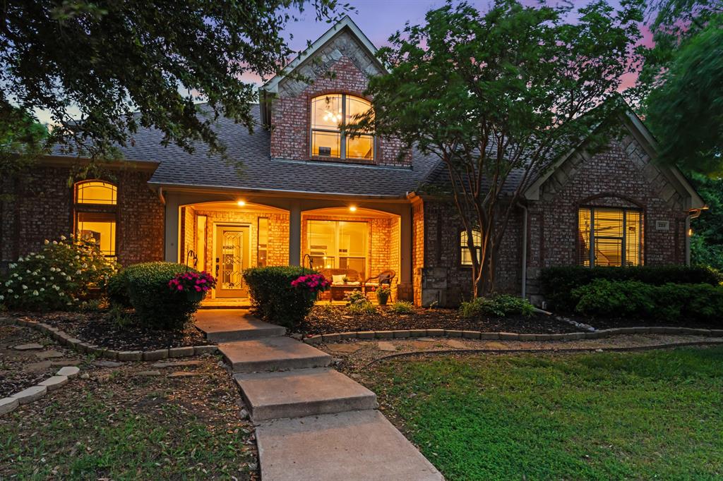 a view of a house with backyard and sitting area