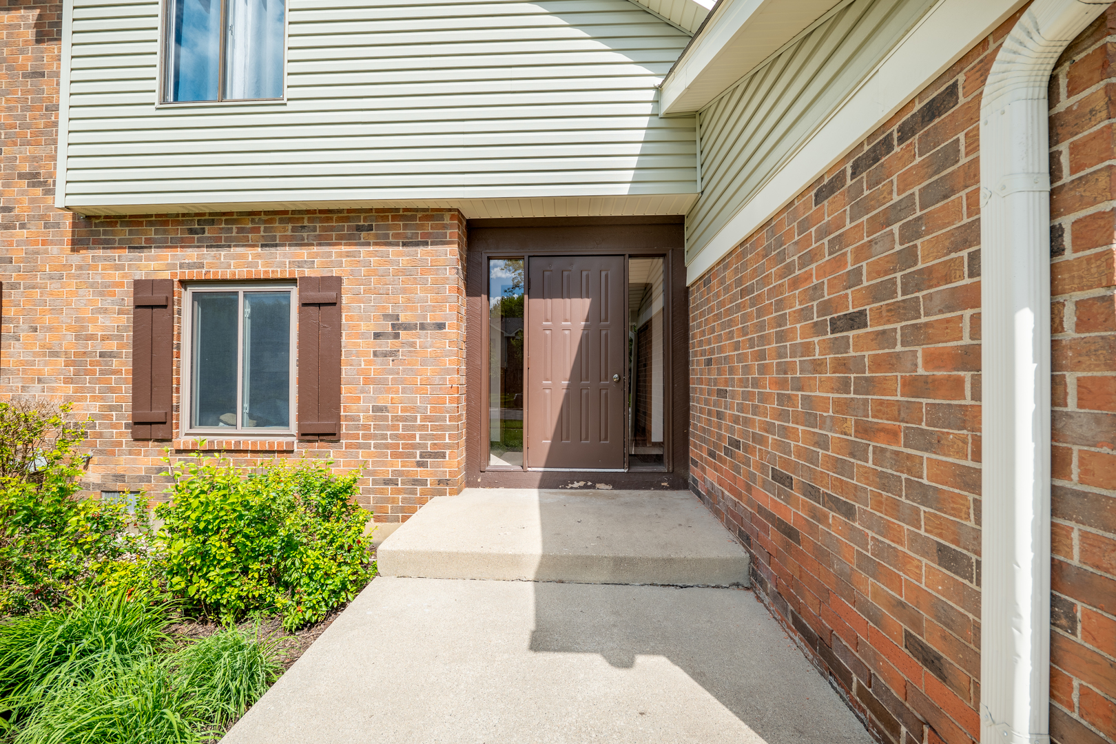 a view of a brick house with a large windows