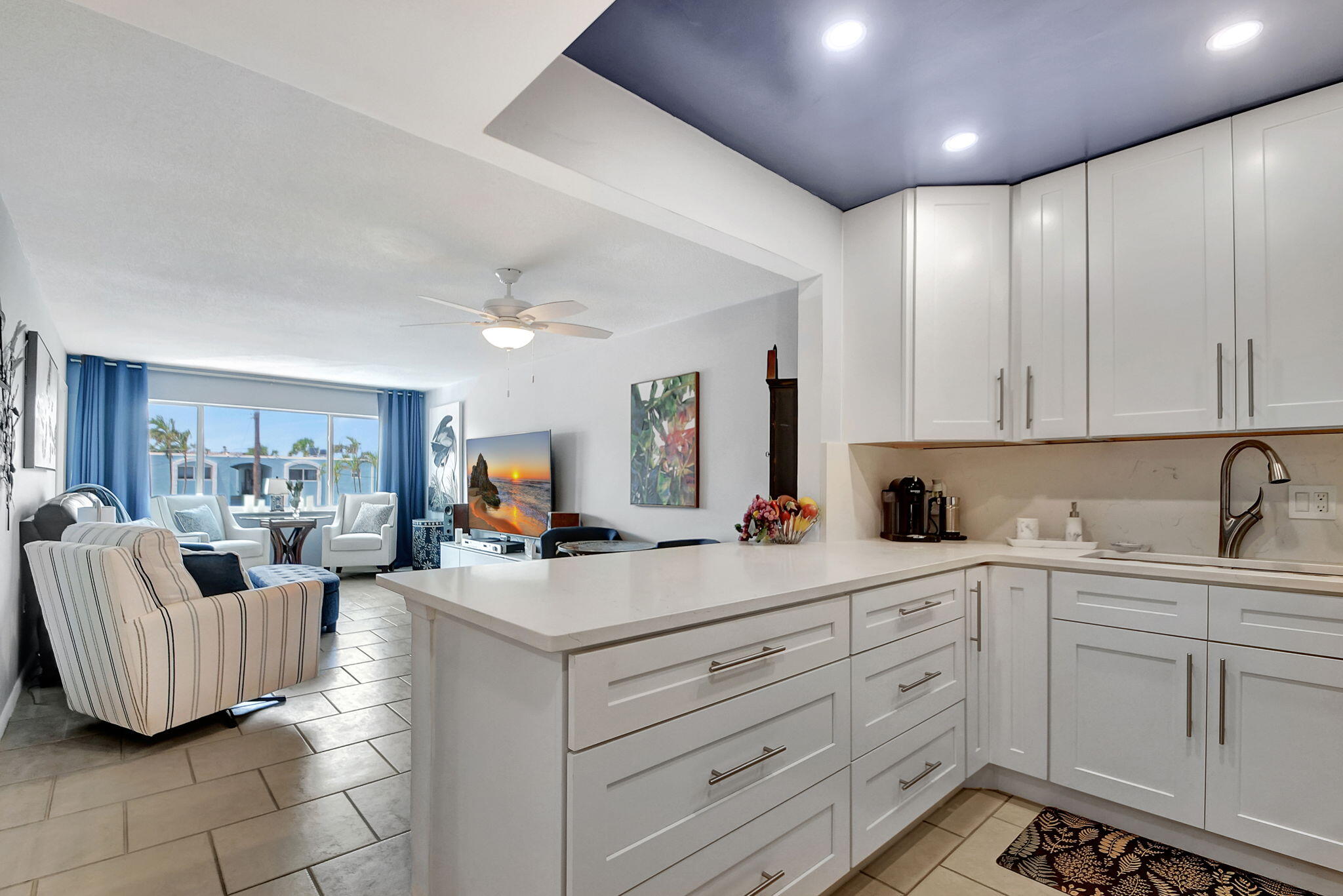 a kitchen with sink cabinets and living room