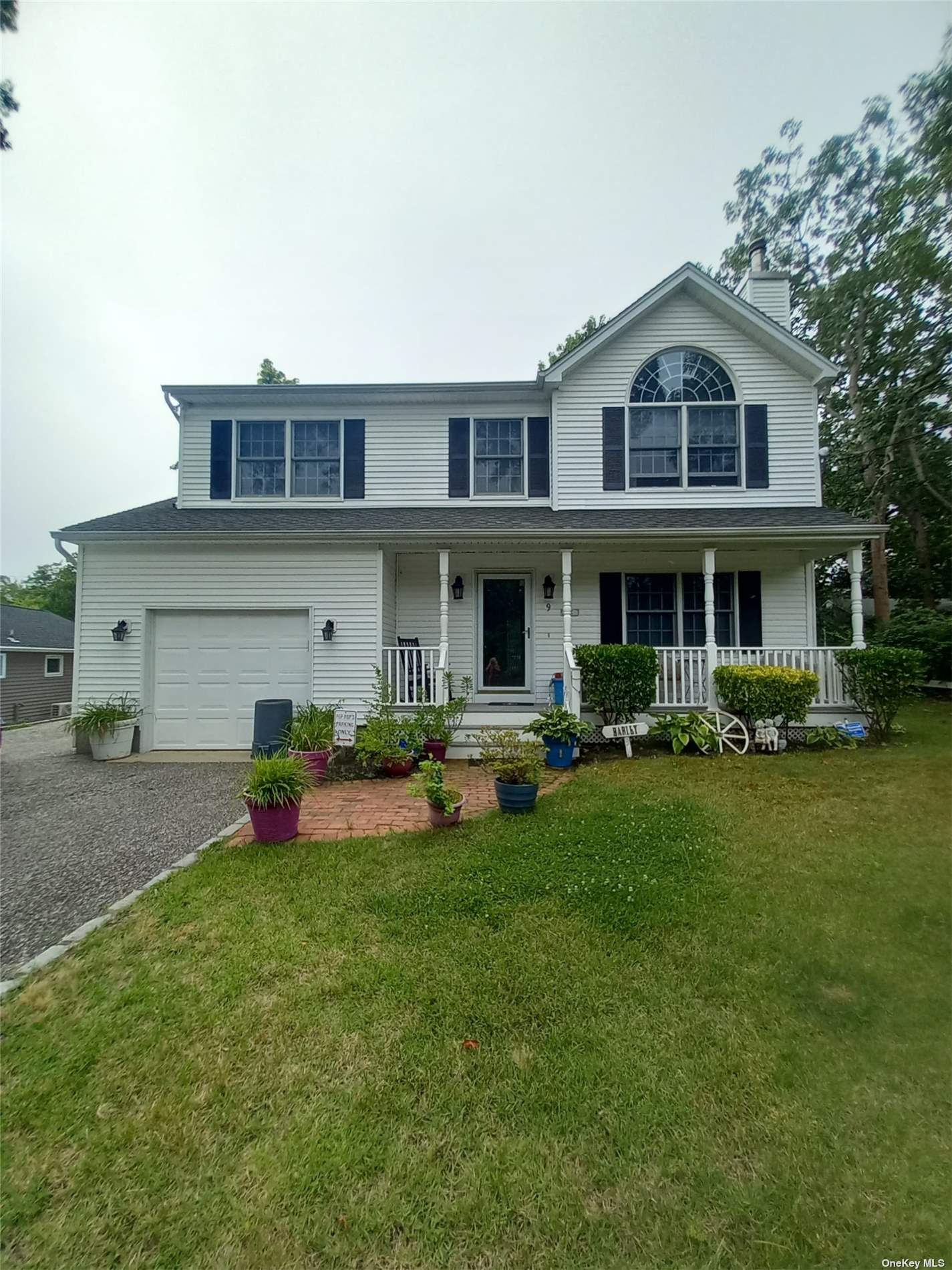 a front view of a house with a yard and porch