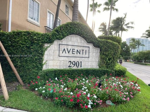 a sign that is sitting in front of flowers