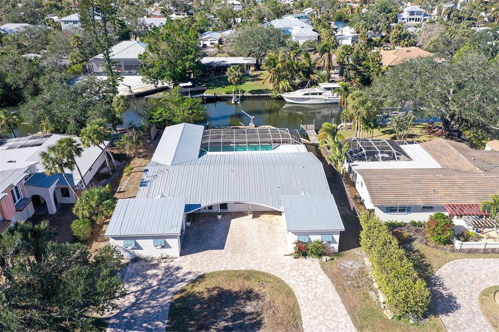 an aerial view of a house with outdoor space and lake view in back