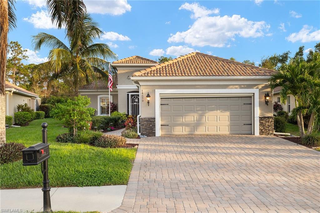 Mediterranean / spanish house with a front lawn and a garage