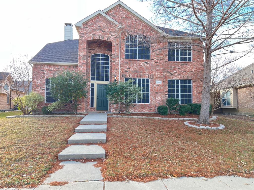 a front view of a house with a yard and a garage