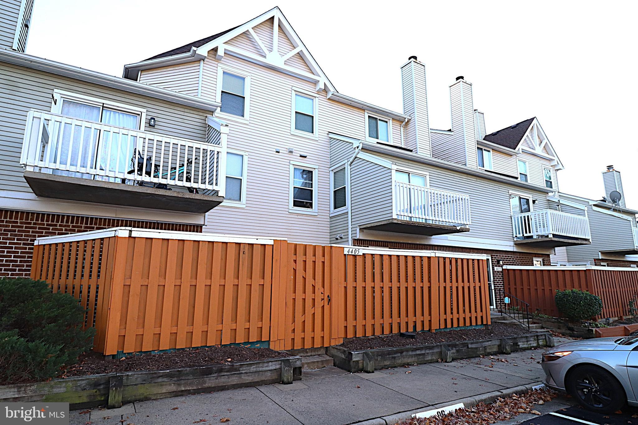 a view of a house with wooden fence