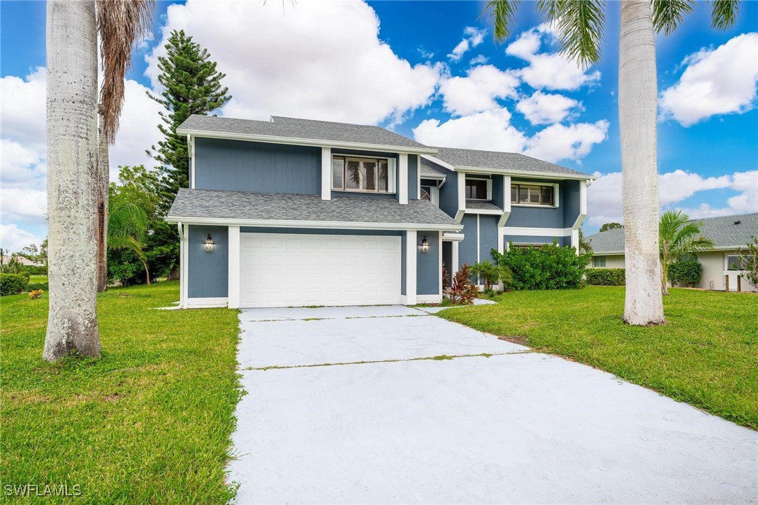 a front view of a house with a yard and garage