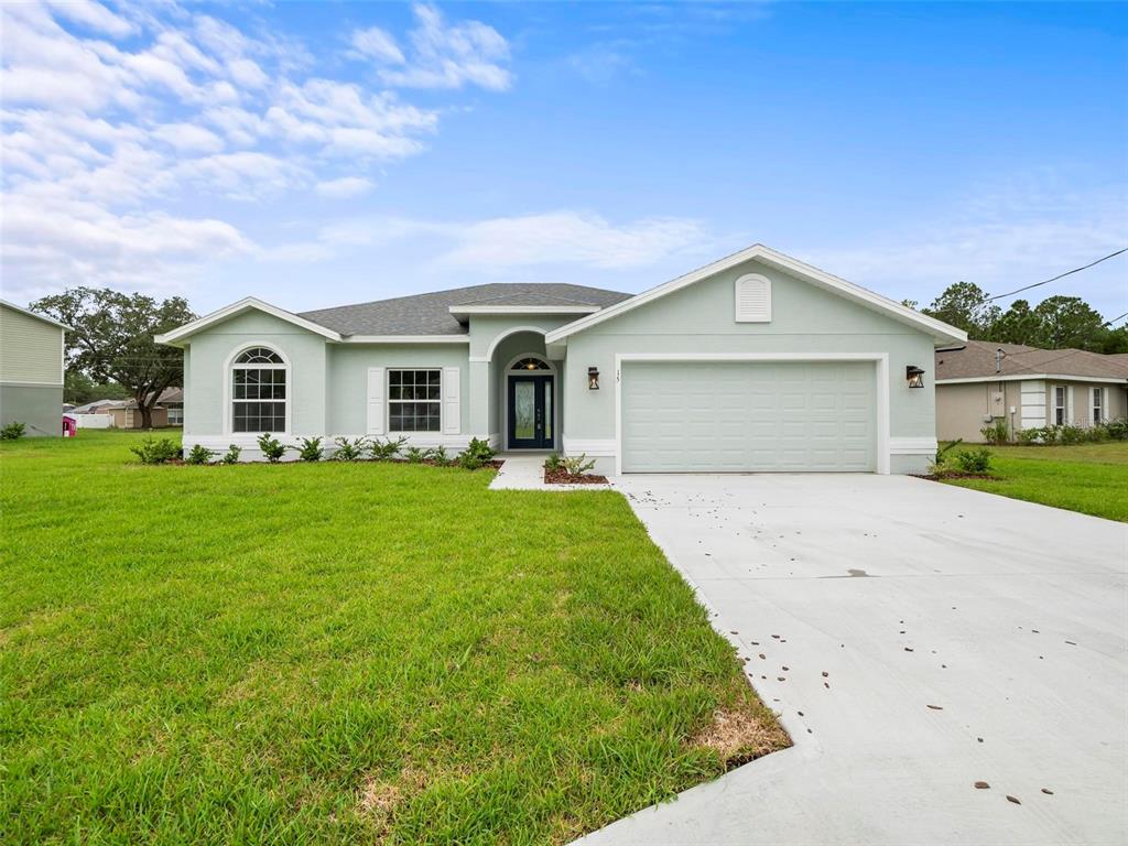 a front view of house with yard and green space