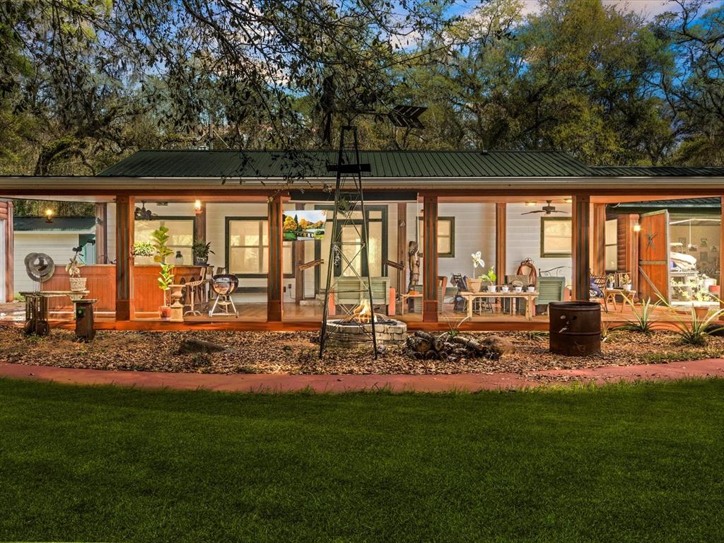 a view of a house with backyard porch and sitting area