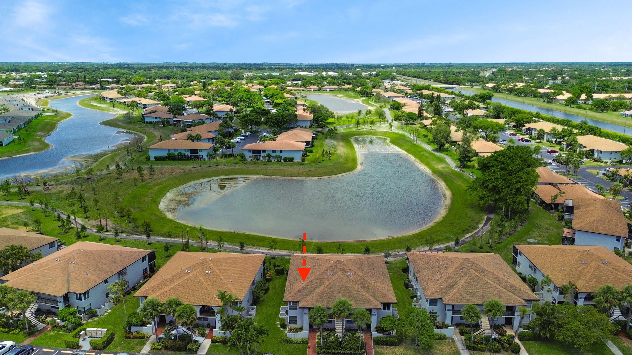 an aerial view of a house with outdoor space and lake view