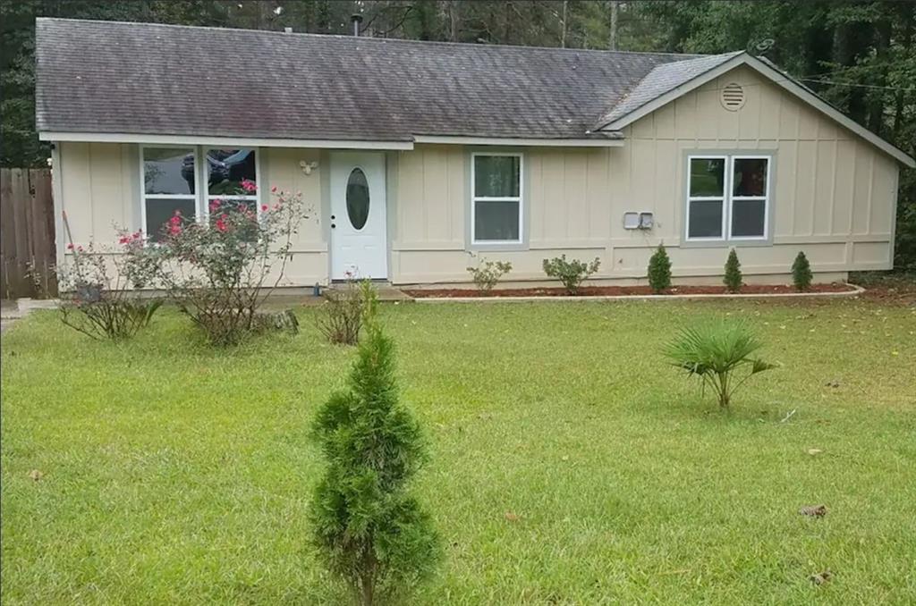 a front view of house with yard and outdoor seating