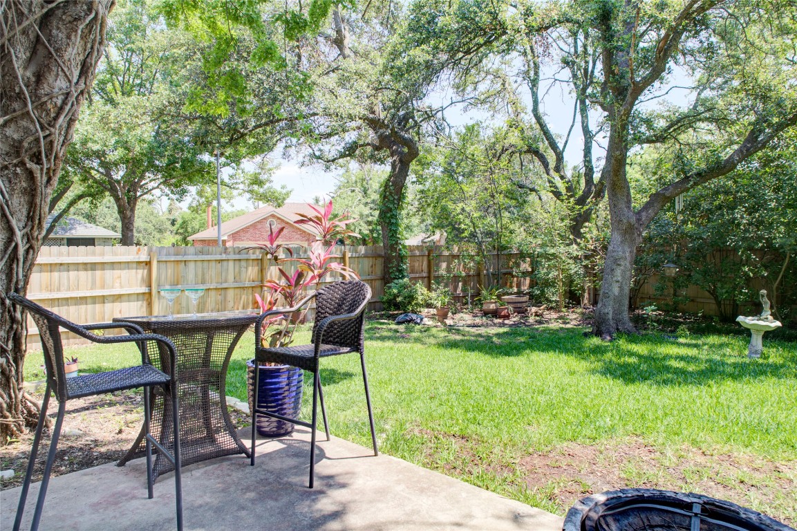 a view of a chairs and table in the garden