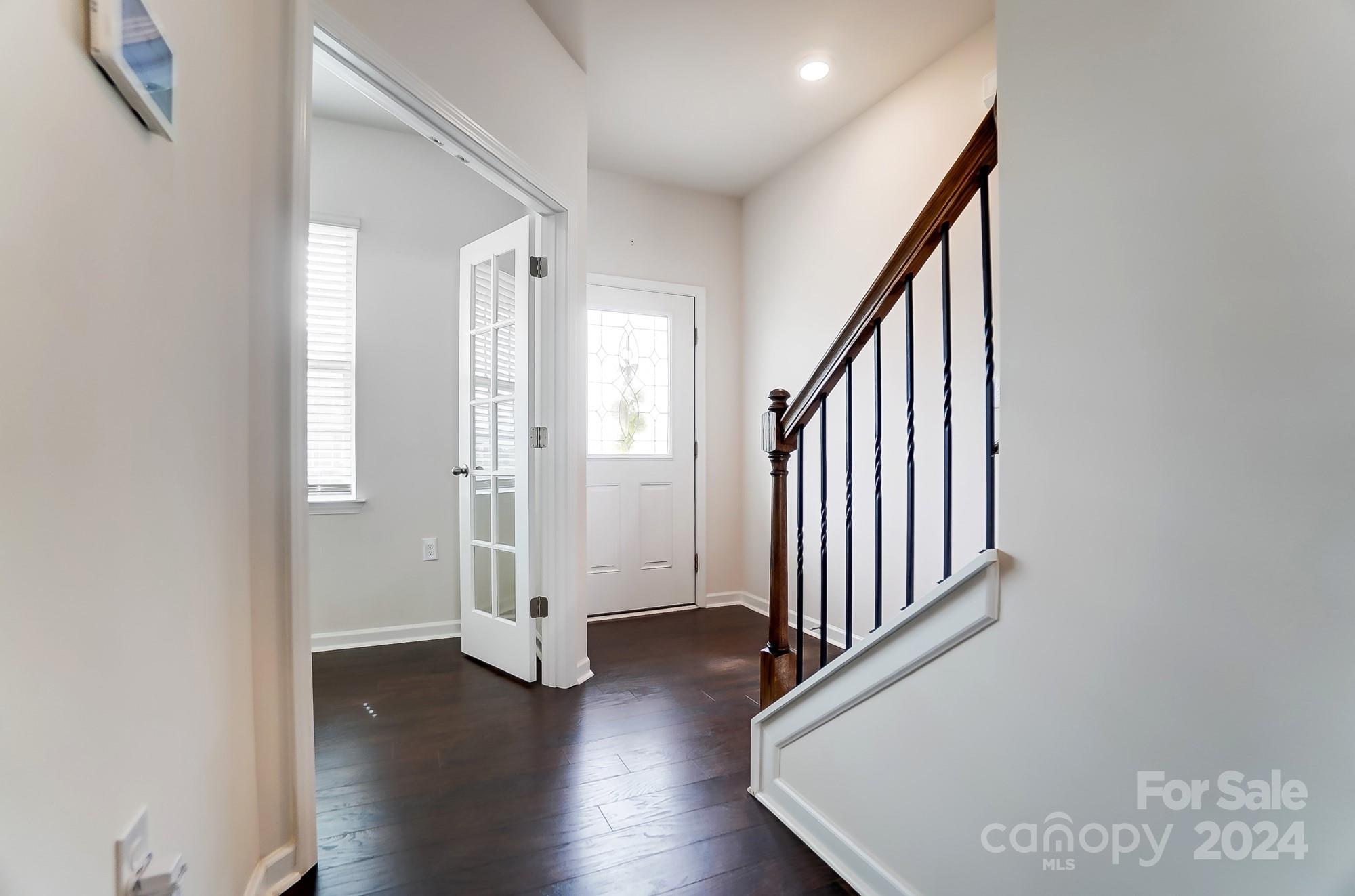 a view of an entryway with wooden floor