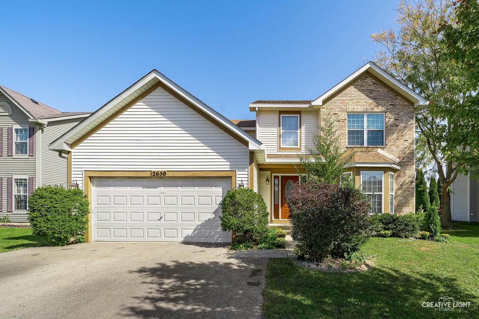 a front view of a house with a yard and garage