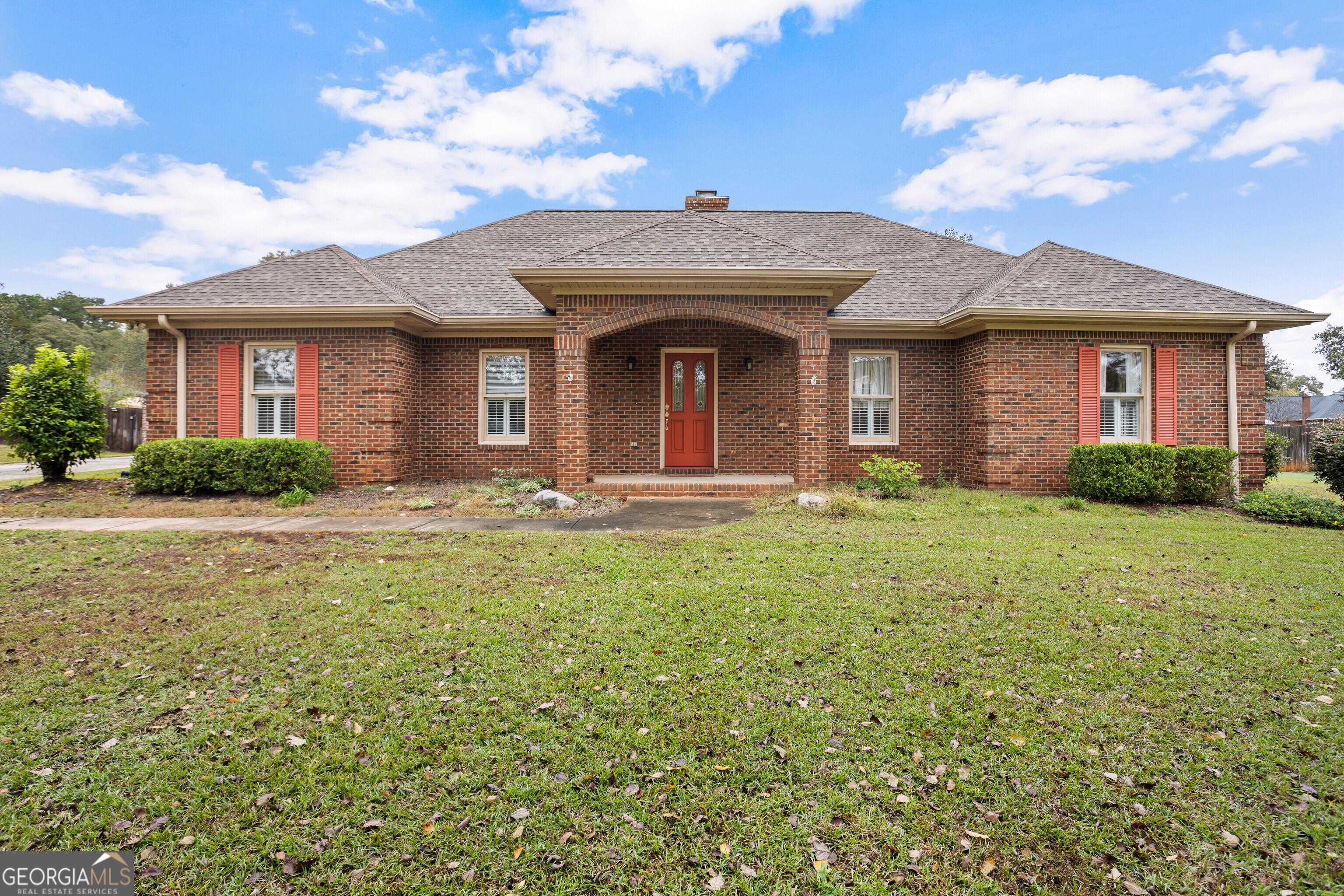 a front view of a house with garden