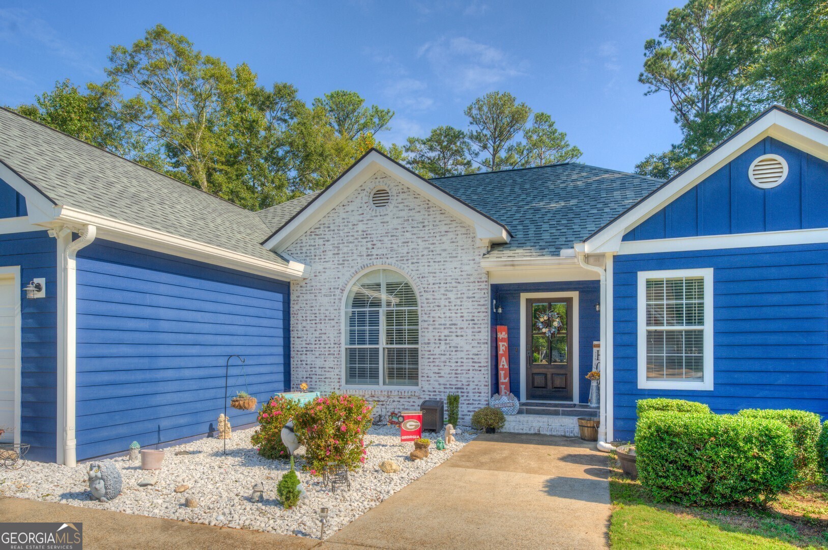 a front view of a house with garden