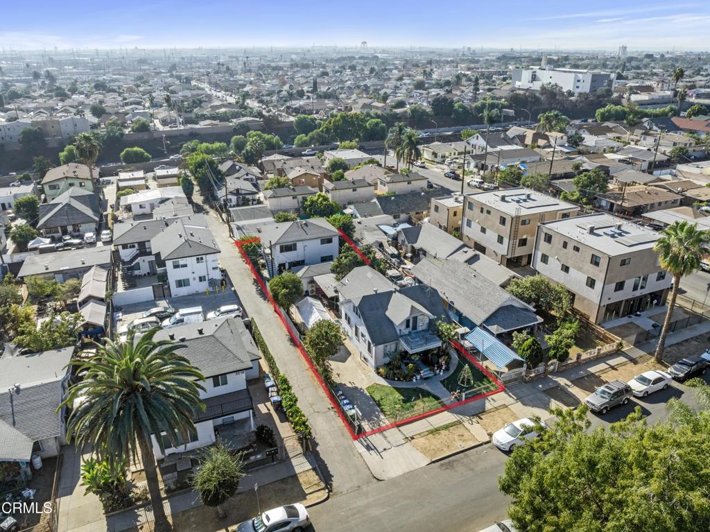 an aerial view of residential houses with outdoor space