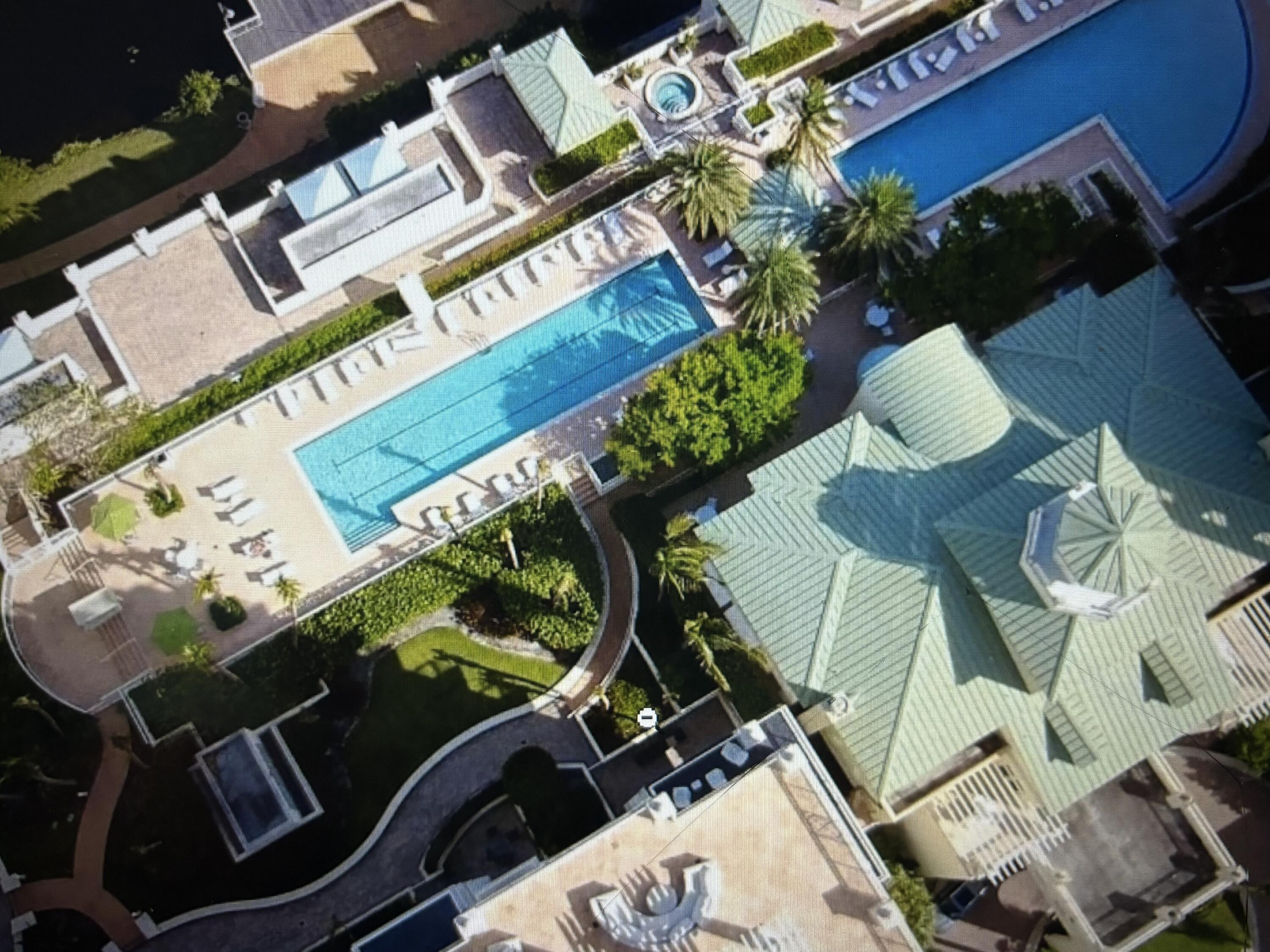 an aerial view of a residential apartment building with a yard