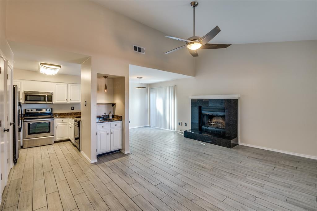 a kitchen with a refrigerator and a stove top oven