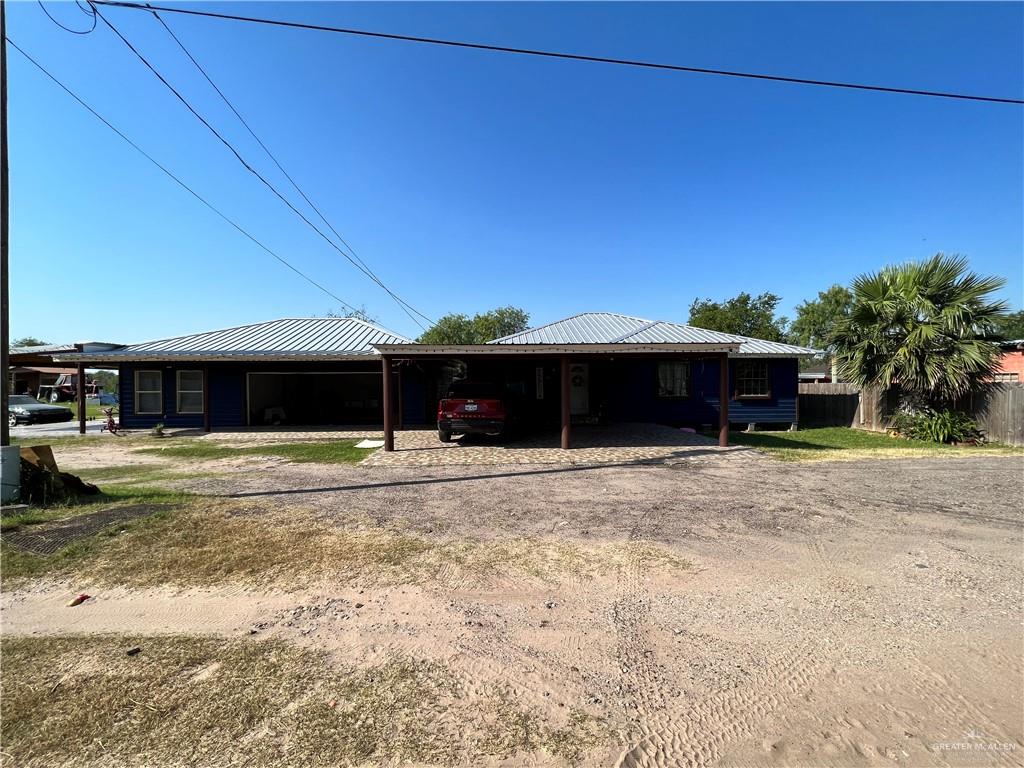 a front view of a house with a yard and a garage