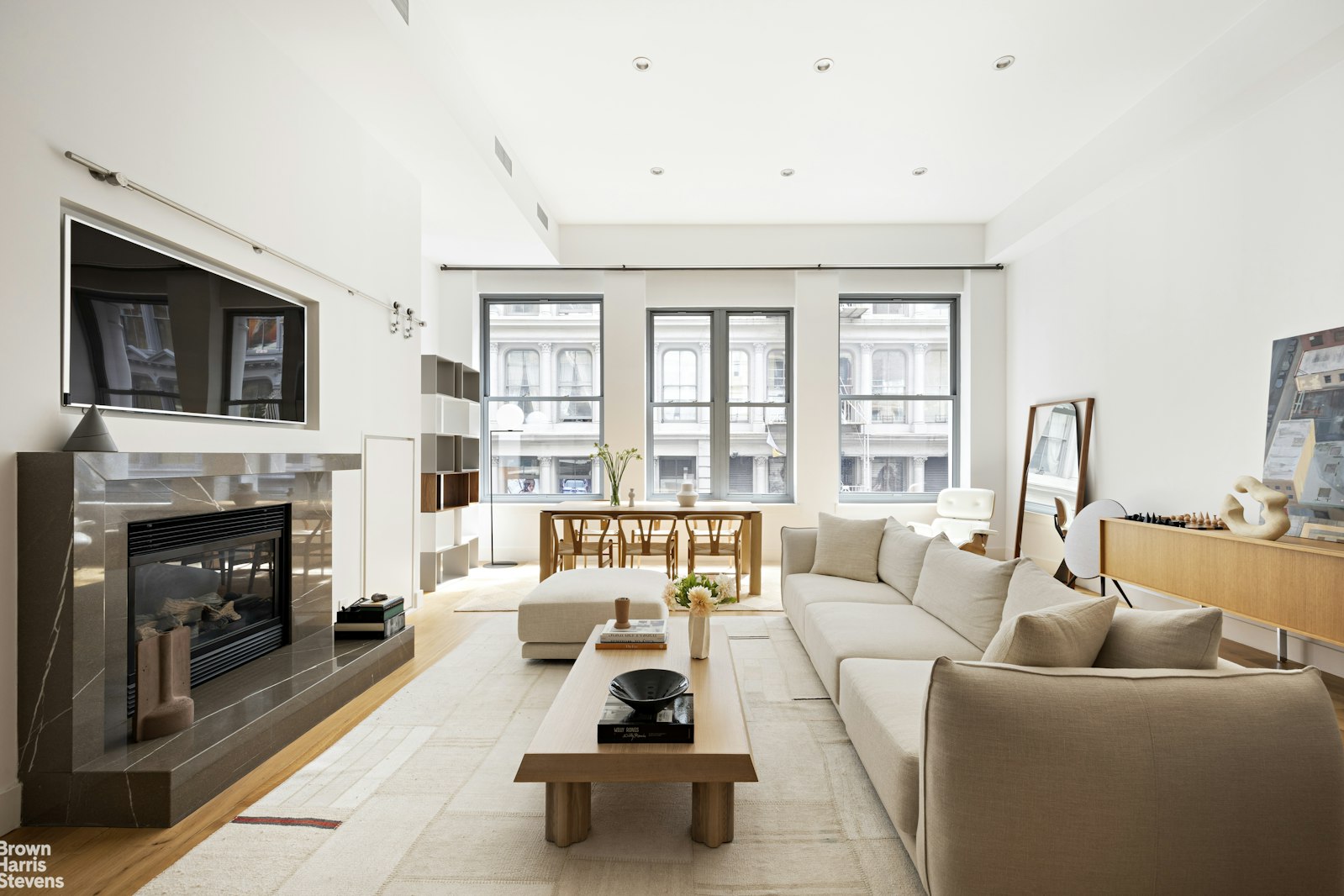 a living room with furniture a fireplace and a flat screen tv