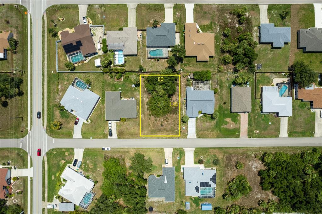 an aerial view of houses with a street