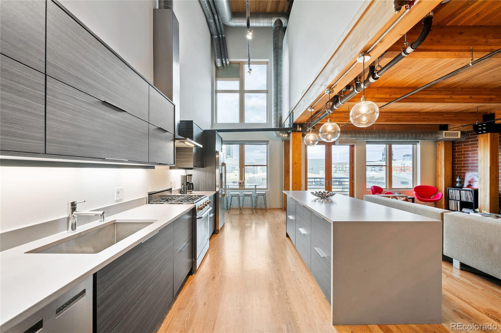 a large white kitchen with a large window