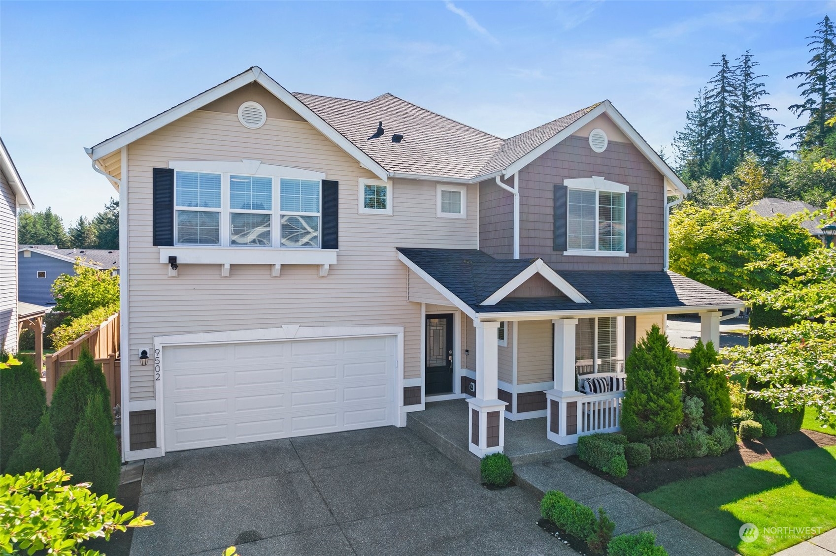 a front view of a house with a yard and garage