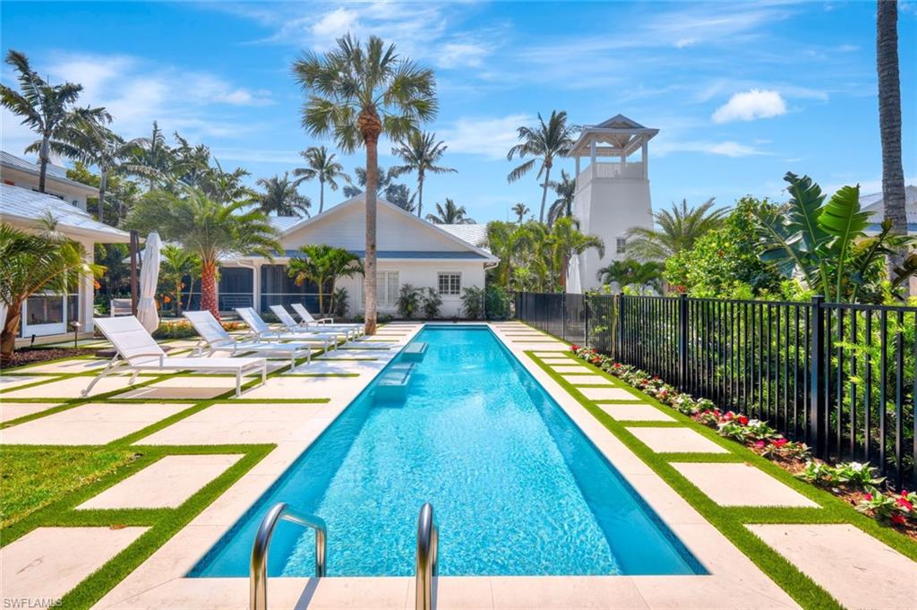 a swimming pool with outdoor seating and yard