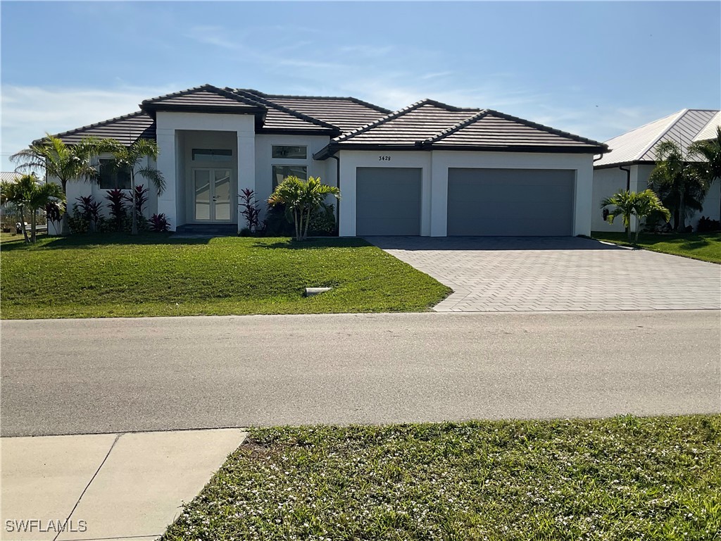 a front view of a house with a yard and garage