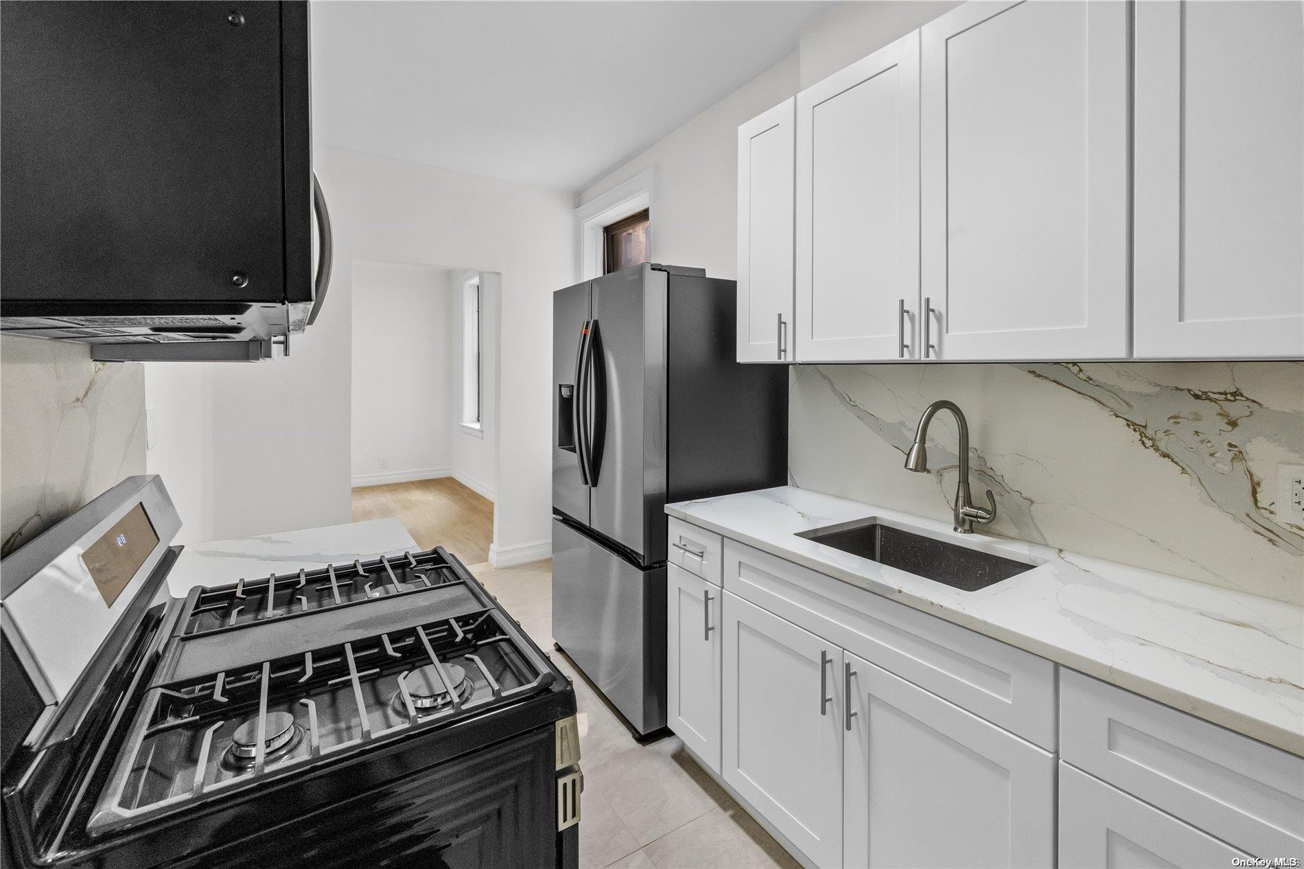 a kitchen with stainless steel appliances granite countertop a stove and a refrigerator