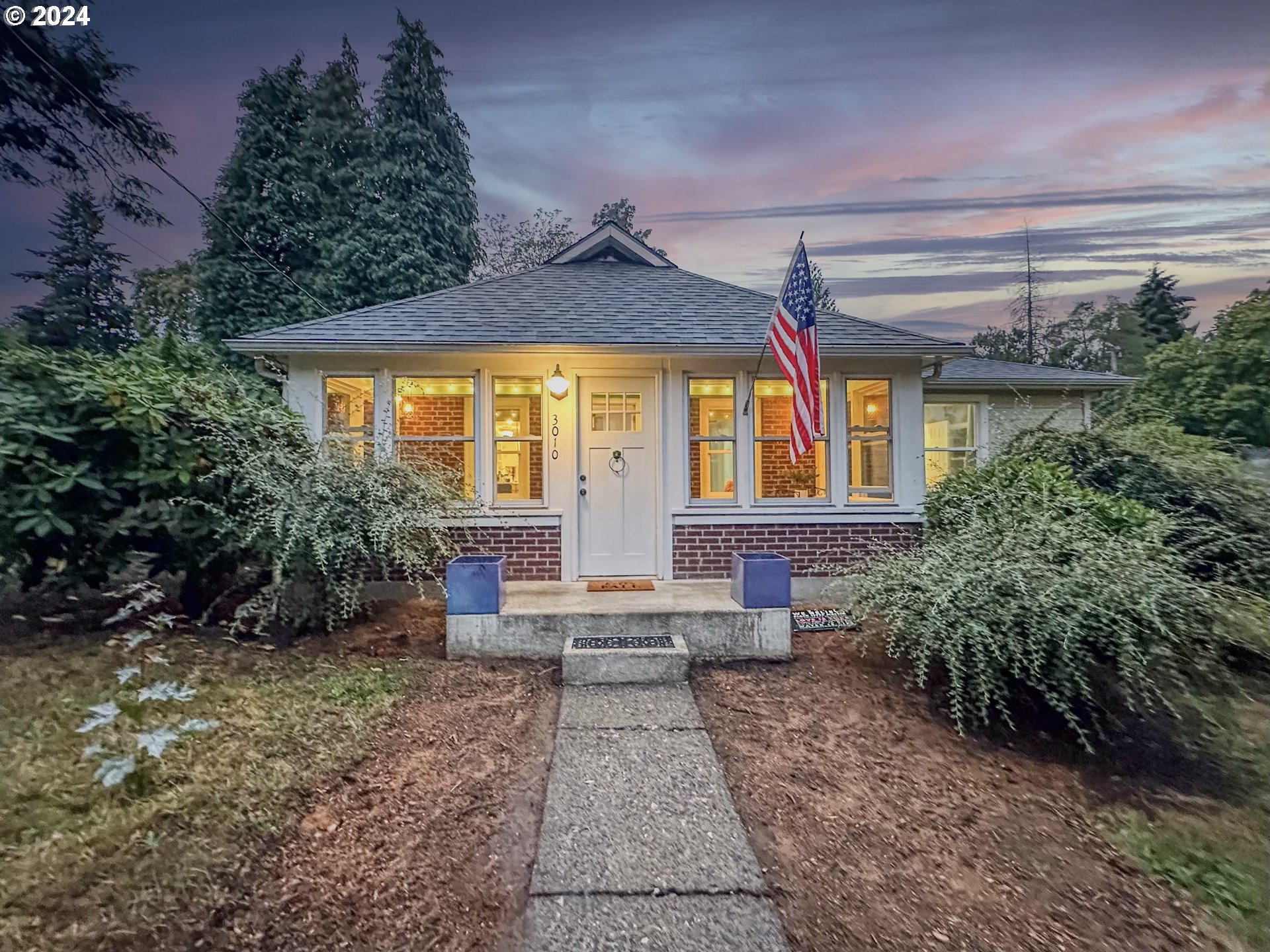 a front view of a house with garden