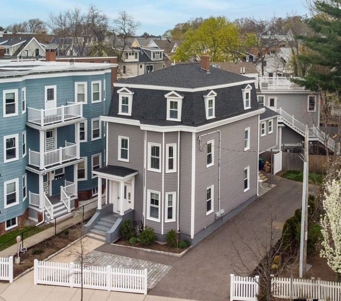 a front view of a residential apartment building with a yard