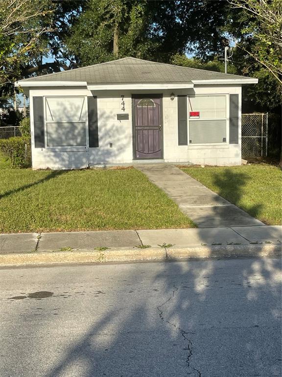 a front view of a house with a garden and garage